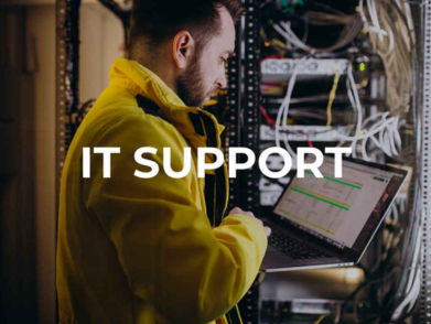 IT professional using a laptop to check IT support and vulnerabilities in server equipment.